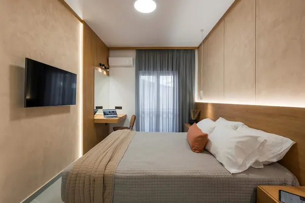 Bedroom with wall-mounted smart TV and workspace, Amara Local Experience