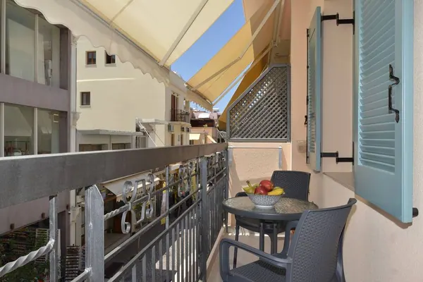 Private balcony with table, chairs and awning overlooking Chania Old Town, Amara Porto Living Apartment 1