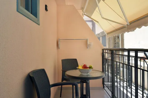 Private balcony with bistro table and chairs, Amara Porto Living Studio