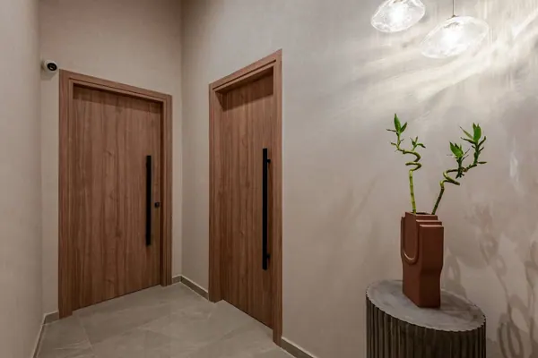Suite entrance with timber doors and ceramic vase, Amara Luxury Suites Chania