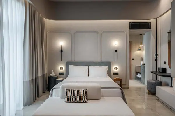 King-size bed with wall sconces and ensuite beyond, Amara Luxury Suite with Terrace