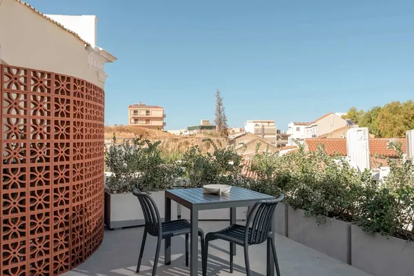 Furnished private terrace with terracotta screen and rooftop view, Amara Luxury Suite, Chania