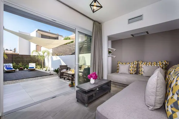 Bedroom opening onto the courtyard through sliding doors, Solar Ground Apartment