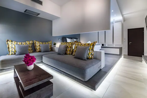 Corner sofa with concealed lighting in the living area, Solar Ground Apartment
