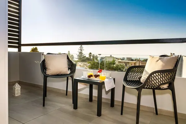 Balcony table and chairs at dusk, Solar Partial Sea View Apartment, Agia Marina