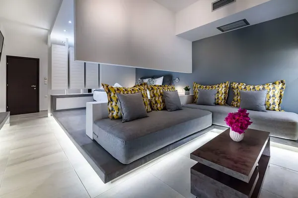 Grey corner sofa and low table in the living area, Solar Standard Apartment, Agia Marina