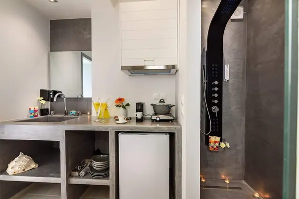 Kitchenette and walk-in shower detail, Solar Apartments by Amara Living