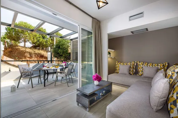 Living area opening onto the shaded balcony, Solar Standard Apartment, Agia Marina