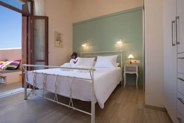Bedroom with iron bed frame and balcony door, Villa Theta by Amara Living
