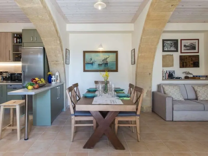 Kitchen with dining table and sofa, the annex at Villa Theta