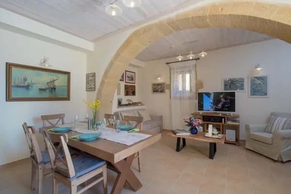 Living and dining area under a stone arch, Villa Theta, Drapanias Crete