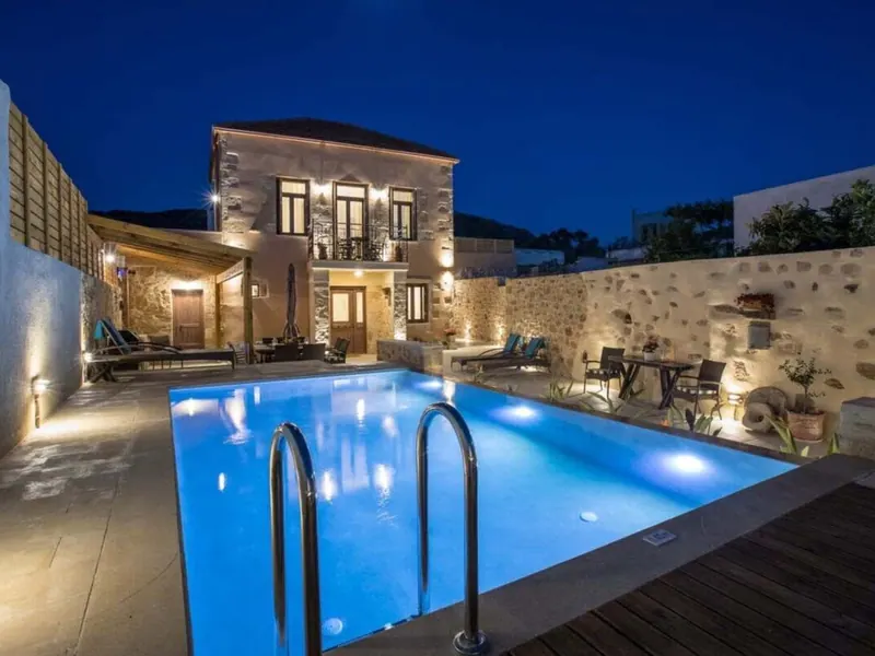 Villa Theta and its private pool lit at dusk, Drapanias, Crete